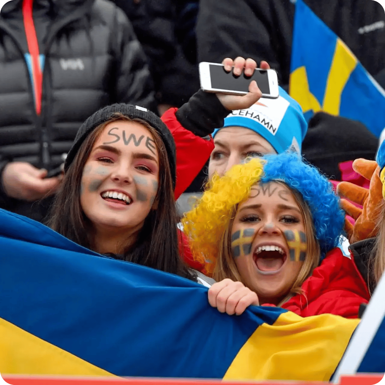 Publik med sverigeperuk och flaggor under World Cup Ulricehamn